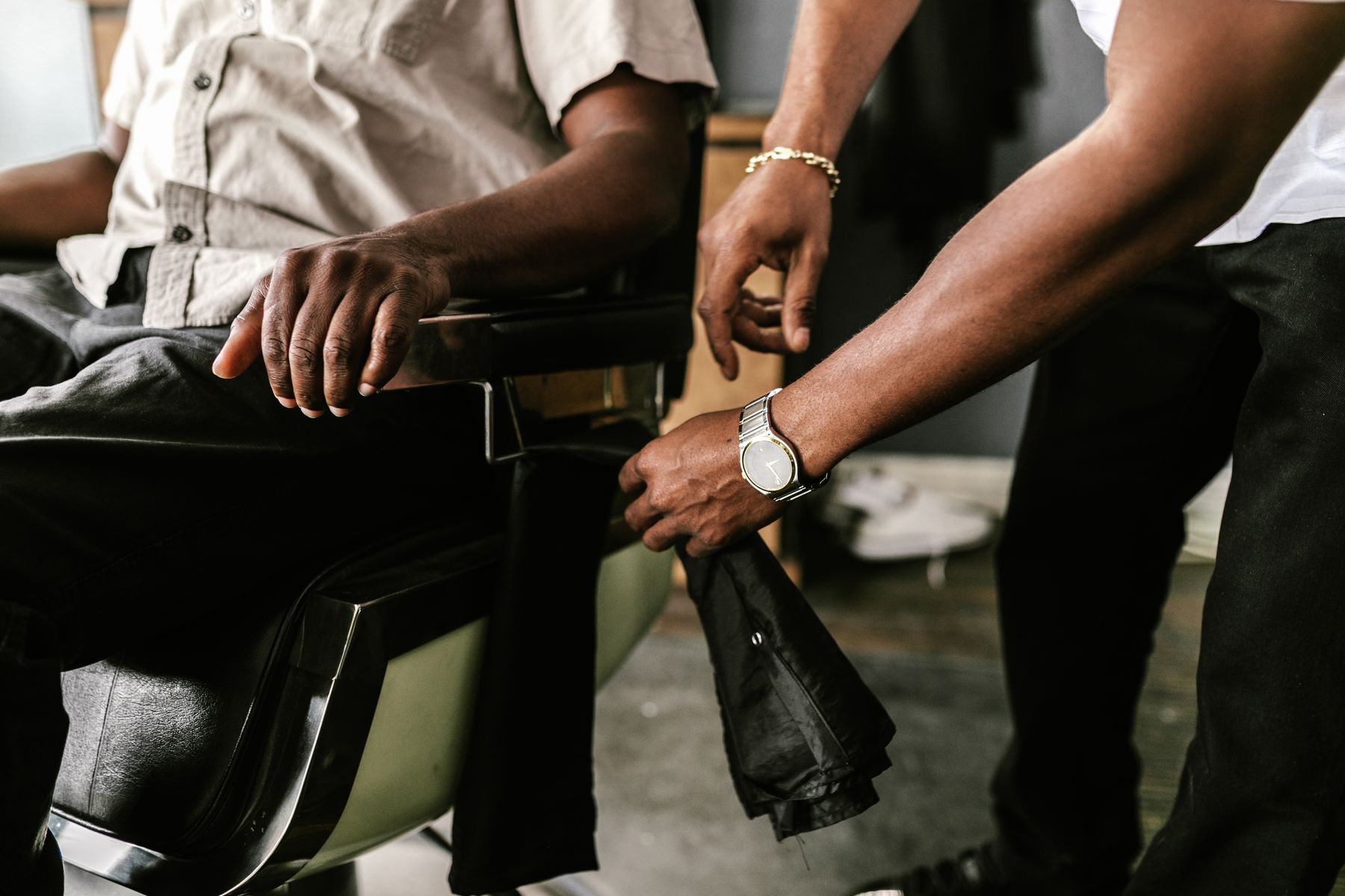 Customer settling into the barber chair at Sharp Cuts