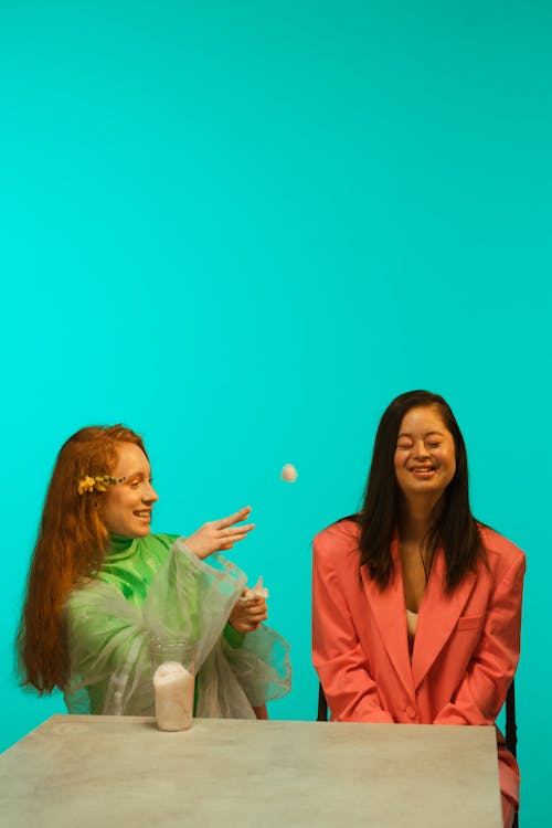 A Woman Flicking a Cotton Ball