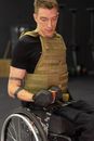 Man in Black T-shirt and Brown Vest Sitting on Wheel Chair