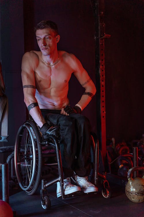 Free A Topless Man Sitting on a Wheelchair Stock Photo