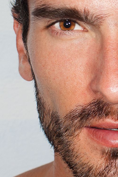 Free Intimate close-up portrait capturing the detailed facial features of a bearded man. Stock Photo