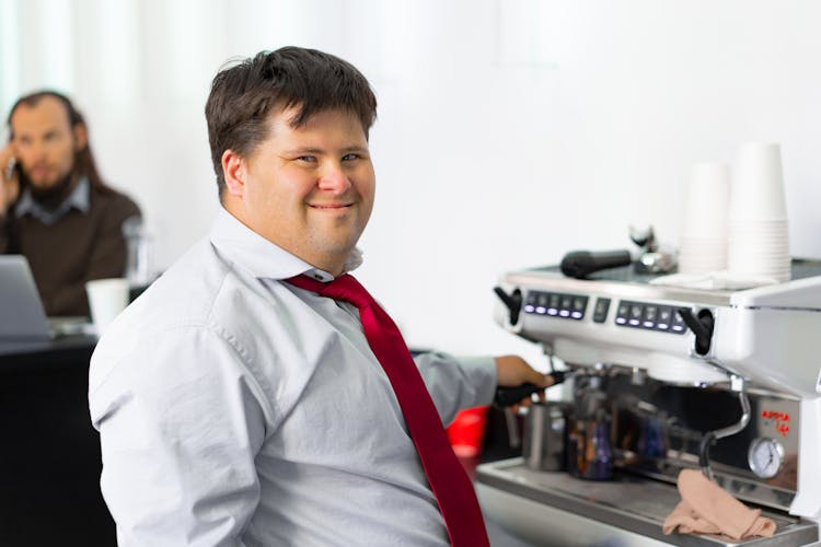 A Happy Man At A Coffee Machine