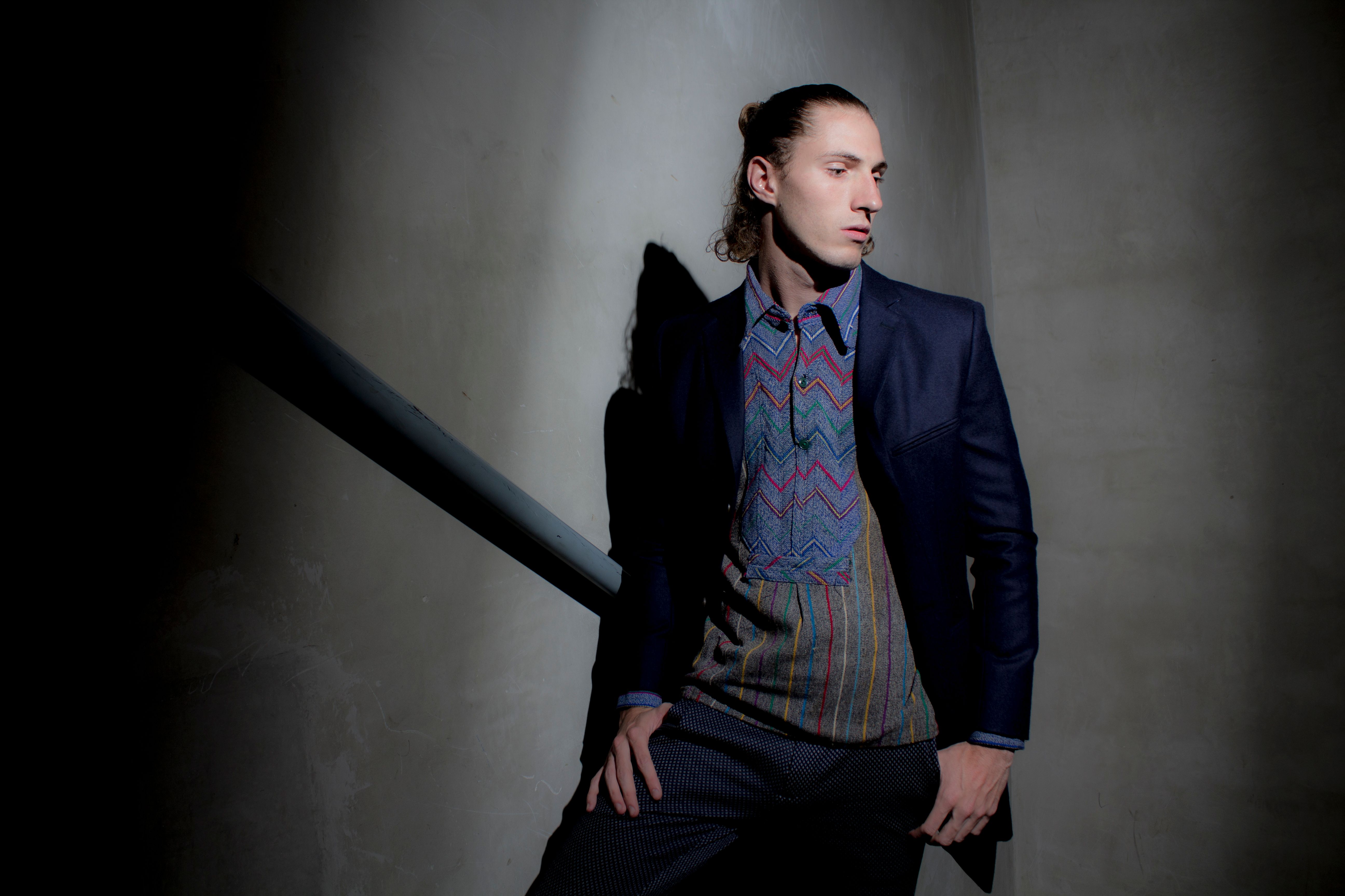 Editorial-style portrait of a well-groomed man in considered styling and lighting