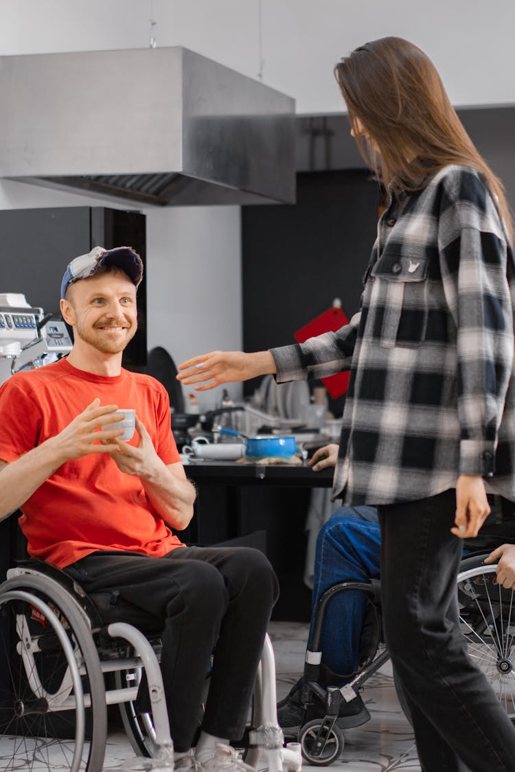 A Happy Man In An Orange Shirt Holding A Cup Of Coffee