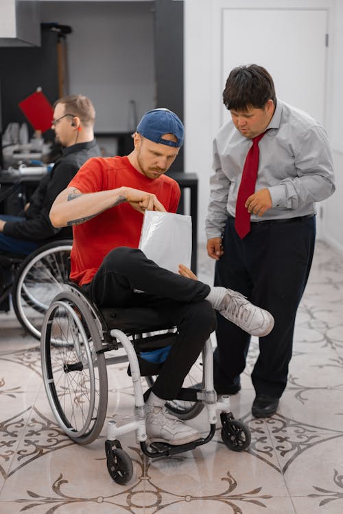 A Man in Red Shirt Sitting on a Wheelchair