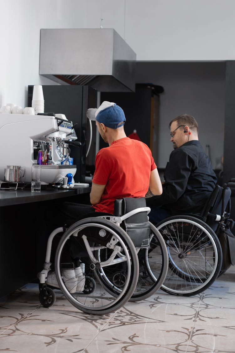 Two Men Sitting On Wheelchairs