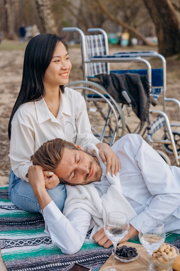 Man Sleeping On The Woman's Lap 