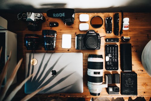 Macbook and Cameras on Wooden Table 