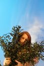Brunette Woman Carrying Green Plants
