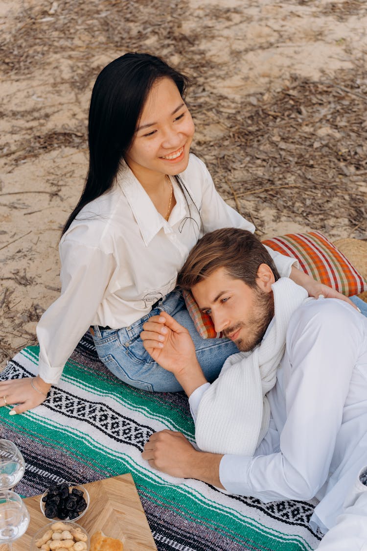 Man Lying On The Smiling Woman's Lap 