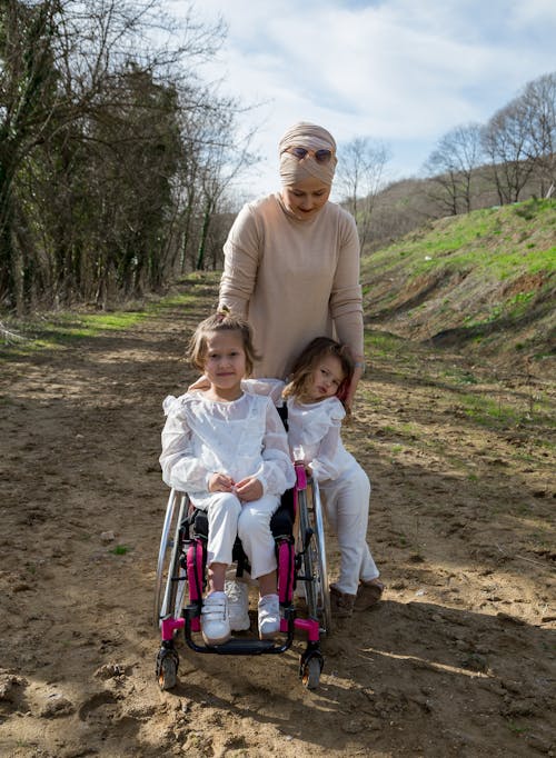 Mother with girl and daughter in wheelchair