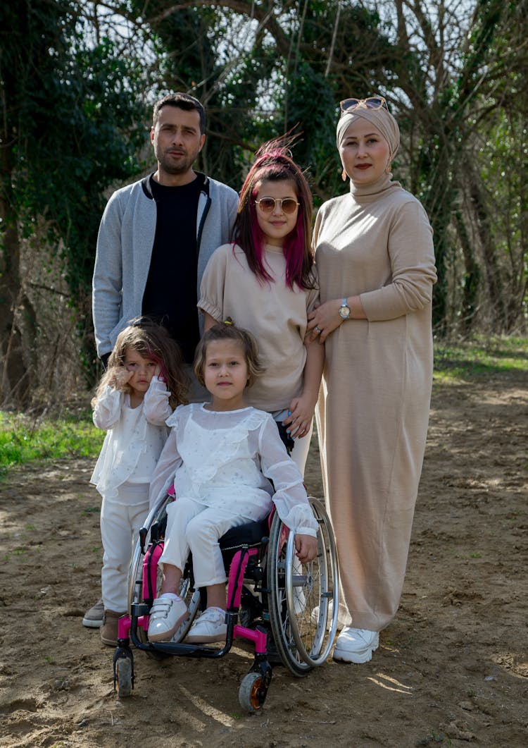 Loving Family With Adorable Daughter And Girl In Wheelchair