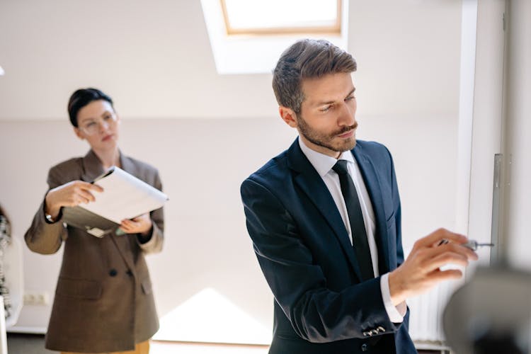 Man In Blue Suit Holding A Screwdriver
