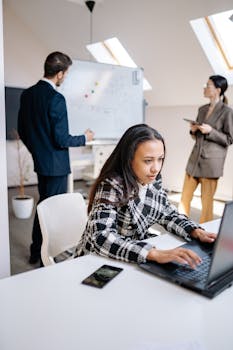 Focused teamwork in a modern office with diverse professionals working efficiently.