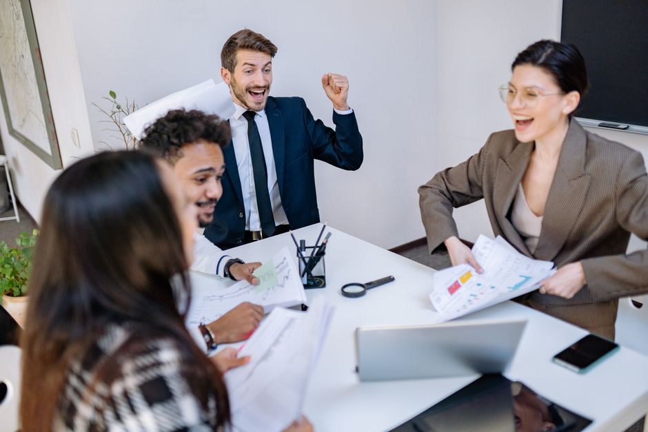 Sales team celebrating improved results after implementing automation - sales process automation