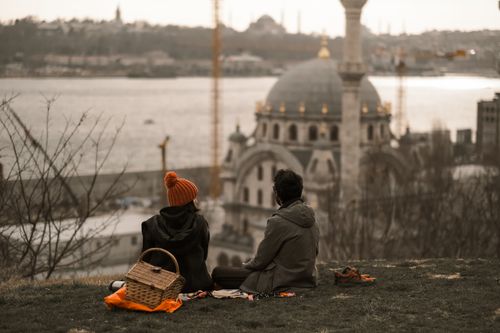 Free Couple enjoying a peaceful moment with a view of Istanbul's iconic skyline. Stock Photo