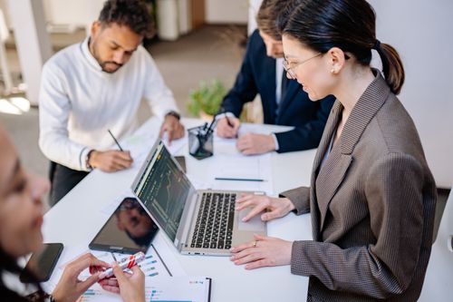 Free Business team collaborating during a market analysis session. Stock Photo
