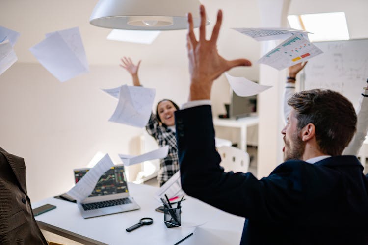 Happy Employees Throwing The Documents 