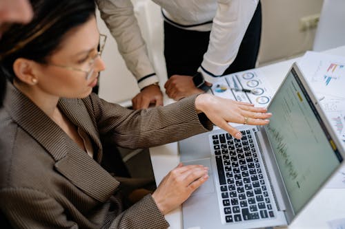 A Woman in Corporate Attire Using a Laptop