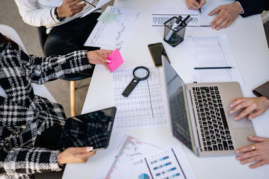 Business professionals collaborating on financial data analysis in a modern office setting.