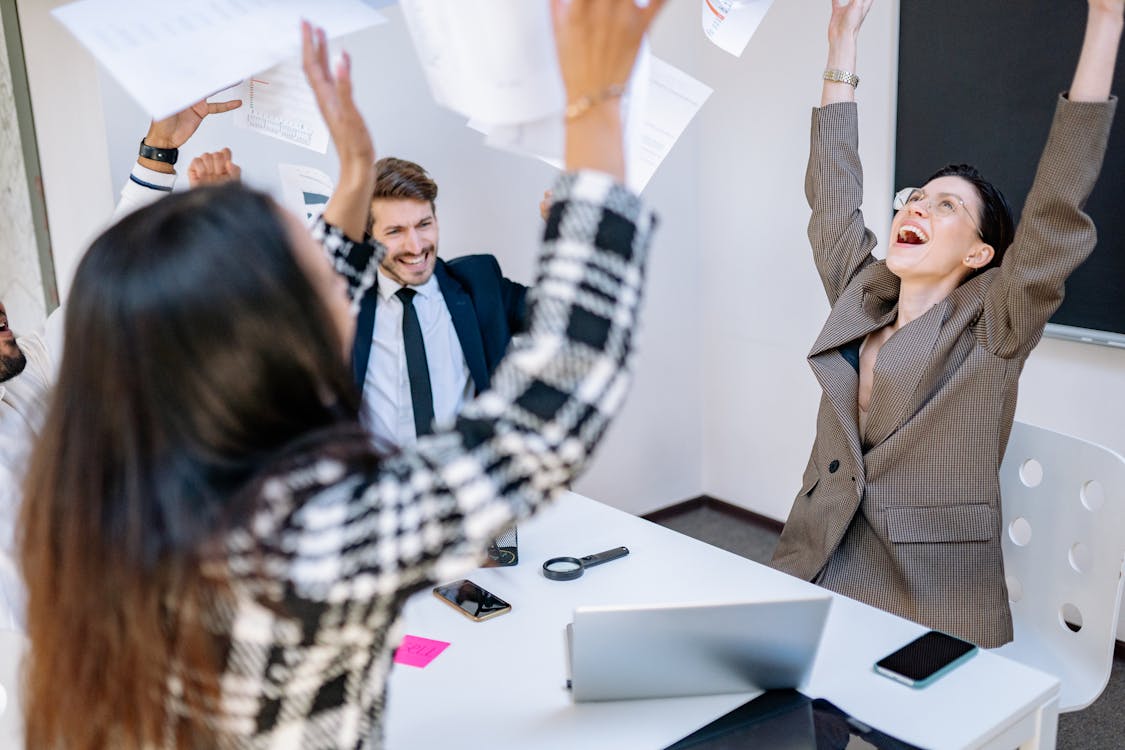 Free Coworkers Tossing Papers at an Office Stock Photo