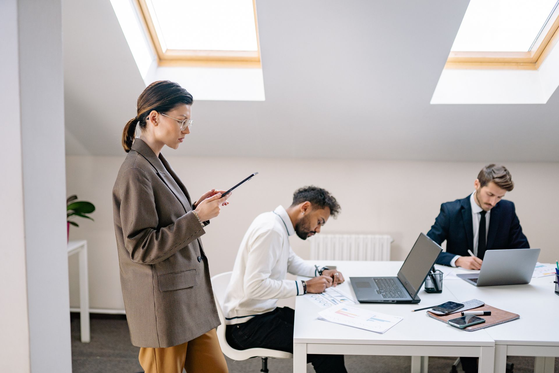 A diverse group of professionals working together in a bright, modern office space.