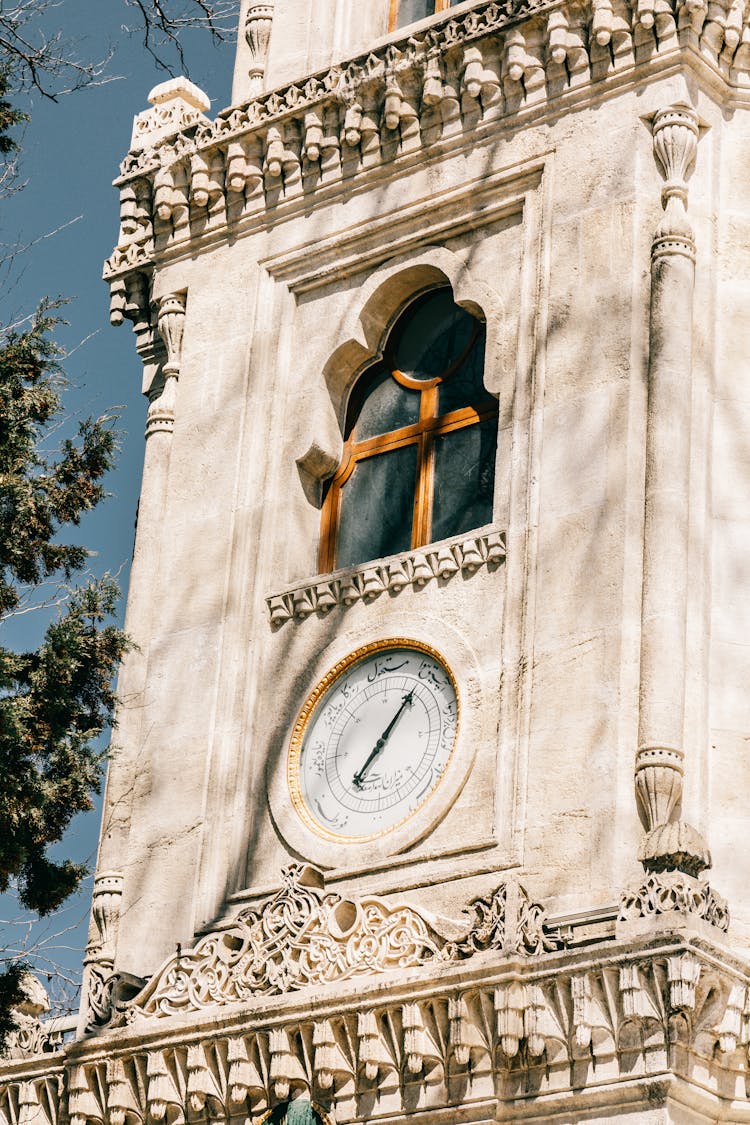 A Clock Tower In Low Angle Shot