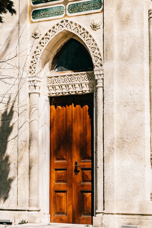 Brown Wooden Door on Beige Concrete Wall