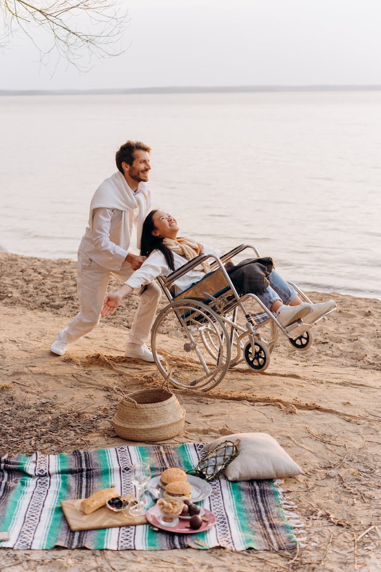 Man Pushing The Woman's Wheelchair 