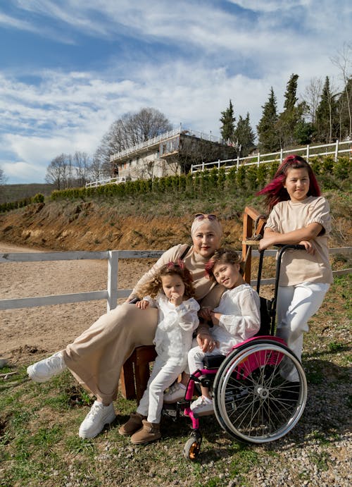 Happy grandmother and cute girls in park