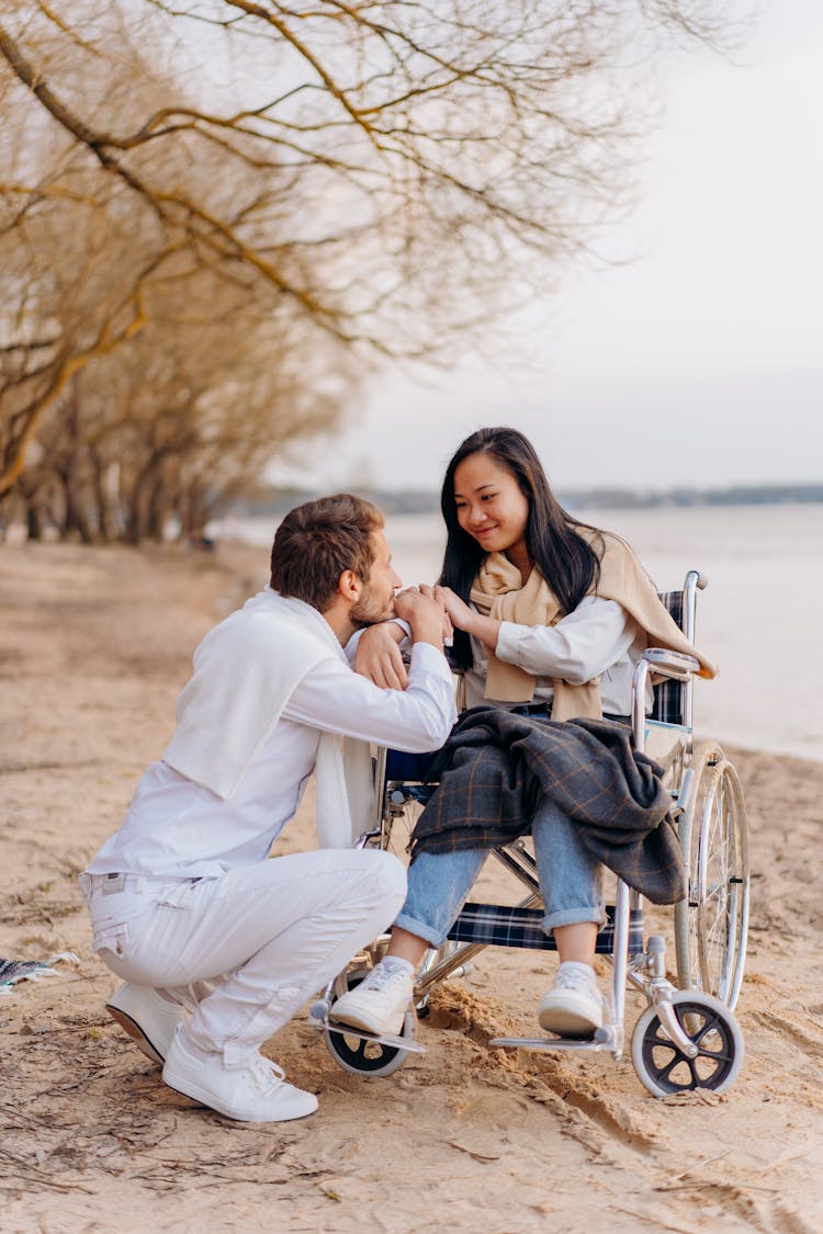 Man Staring At The Woman Sitting On The Wheelchair 