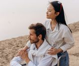 Man and Woman Sitting on Rock