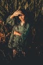 Woman in Green Long Sleeve Blouse Standing on Corn Field
