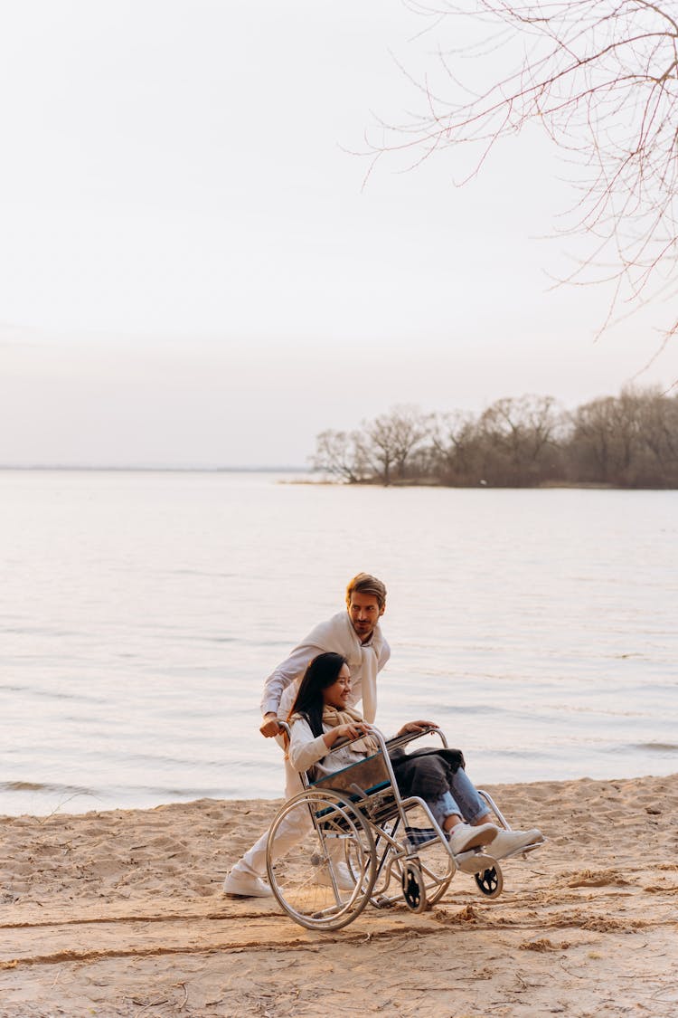 A Man Pushing The Wheelchair 