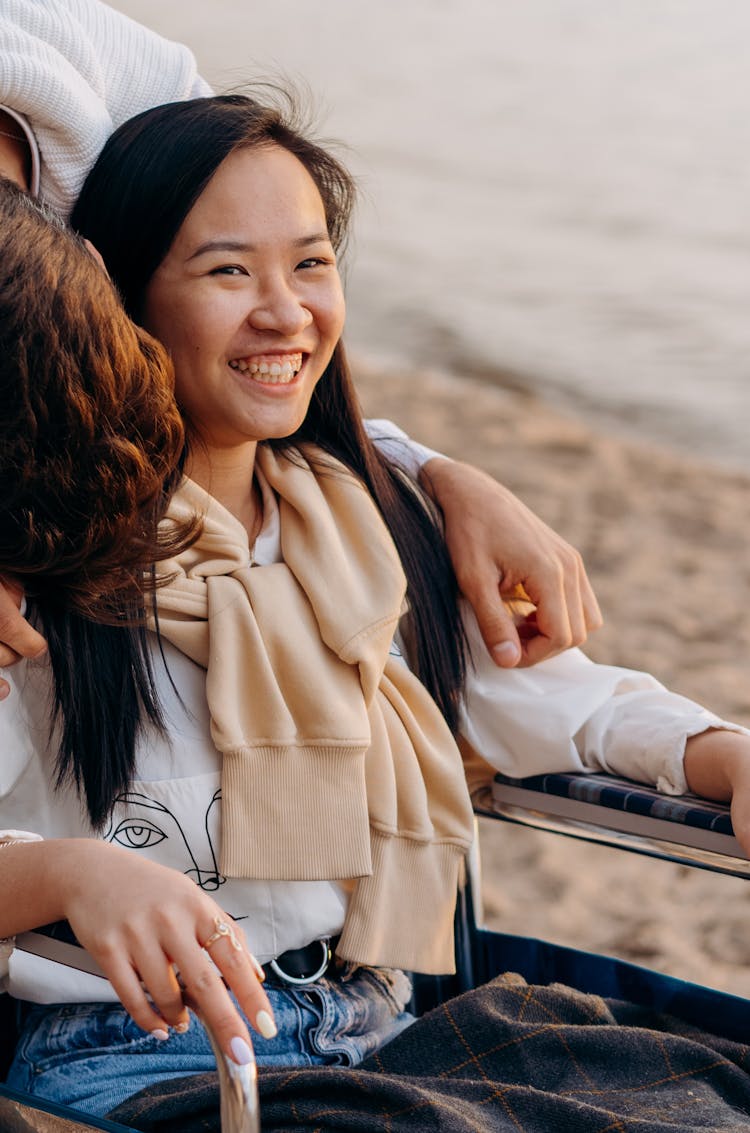 A Happy Woman Sitting On A Wheelchair