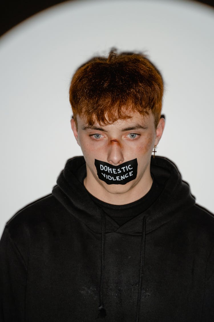 A Young Man's Mouth Covered With Tape