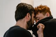 Man in Black Sweater Kissing Woman in Black Shirt