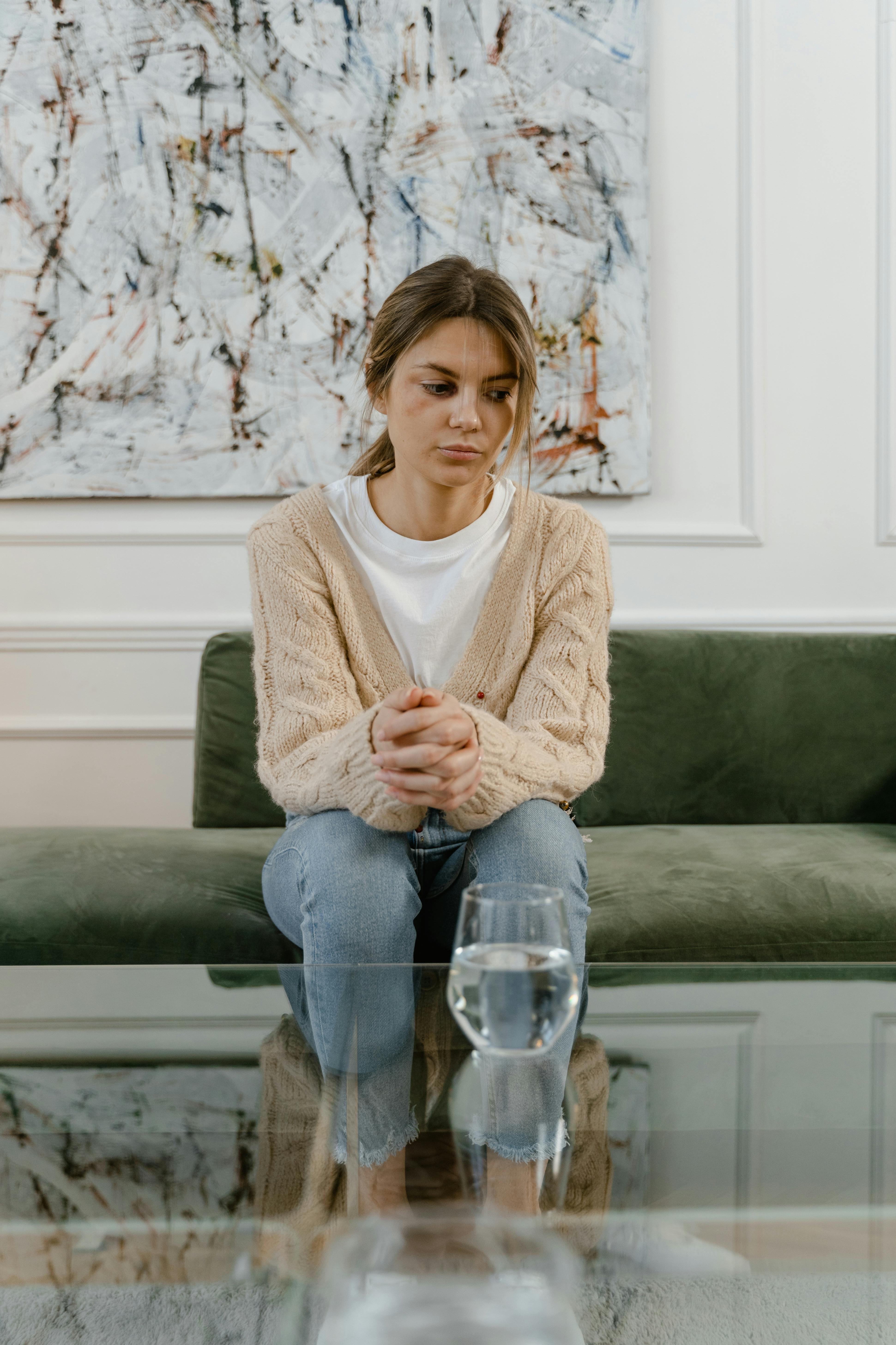 a sad woman sitting on a chair