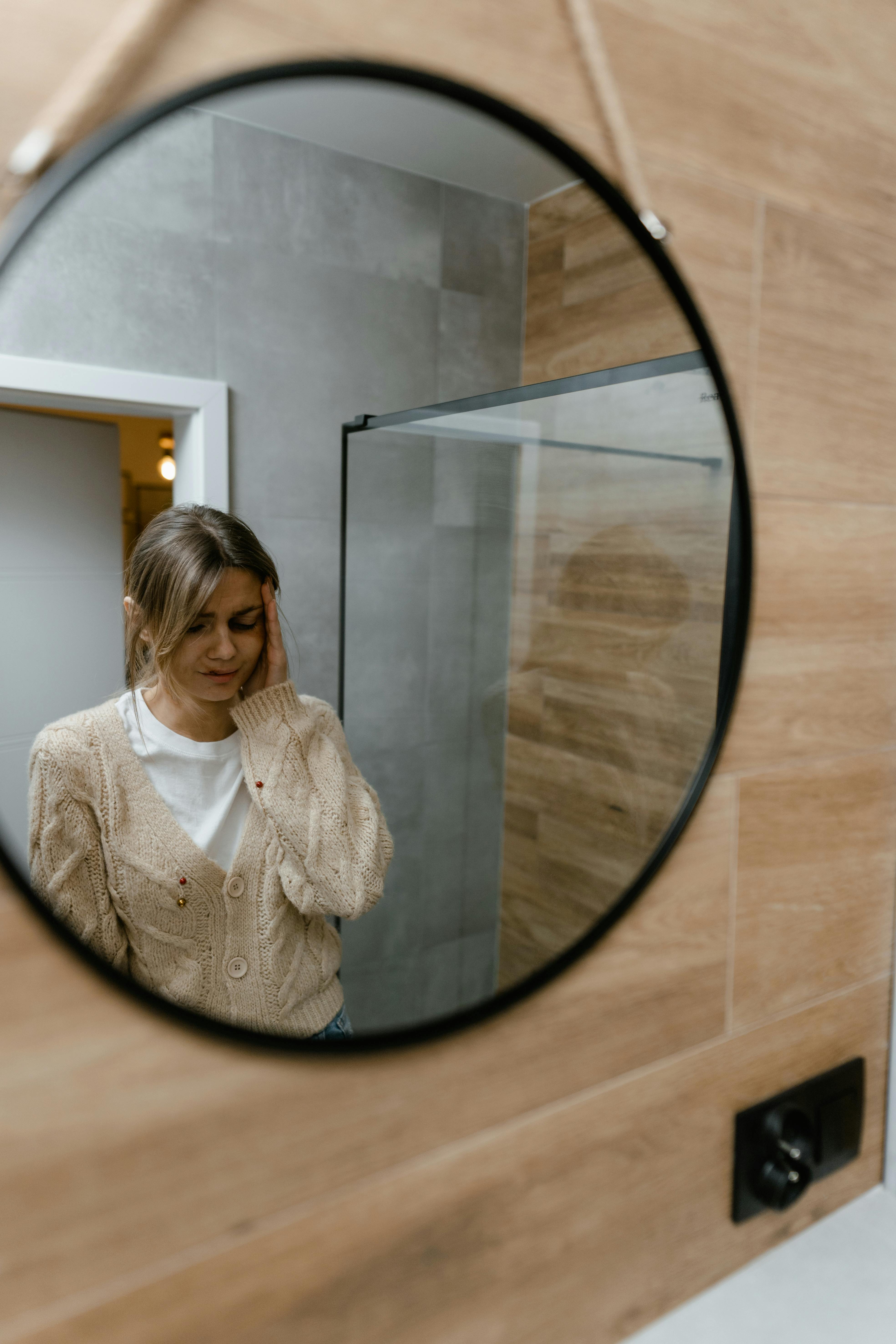 a mirror image of a woman with bruised face