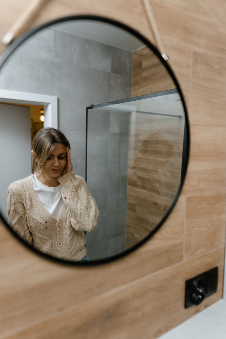  A Mirror Image Of A Woman With Bruised Face