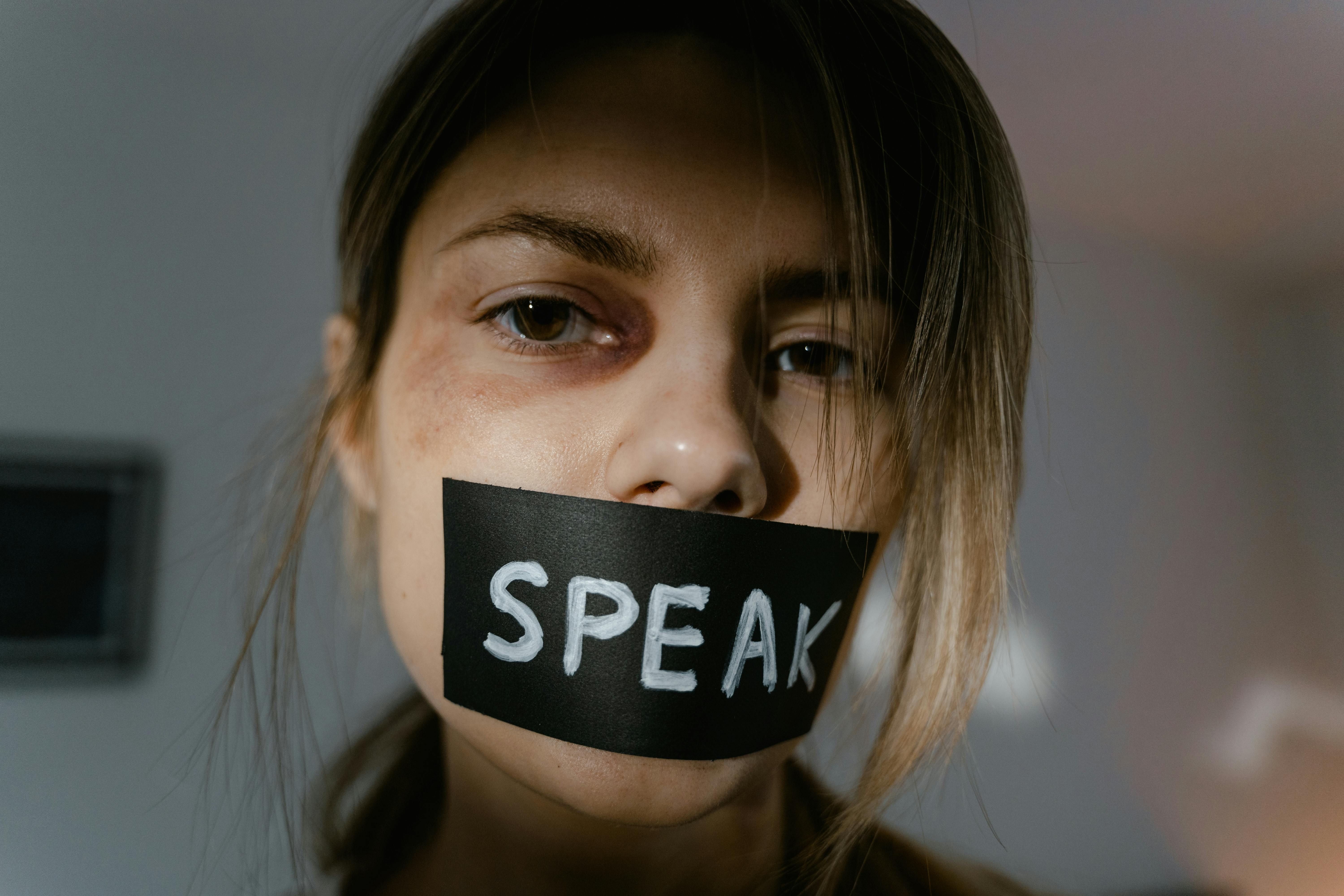 woman with black tape on her lips