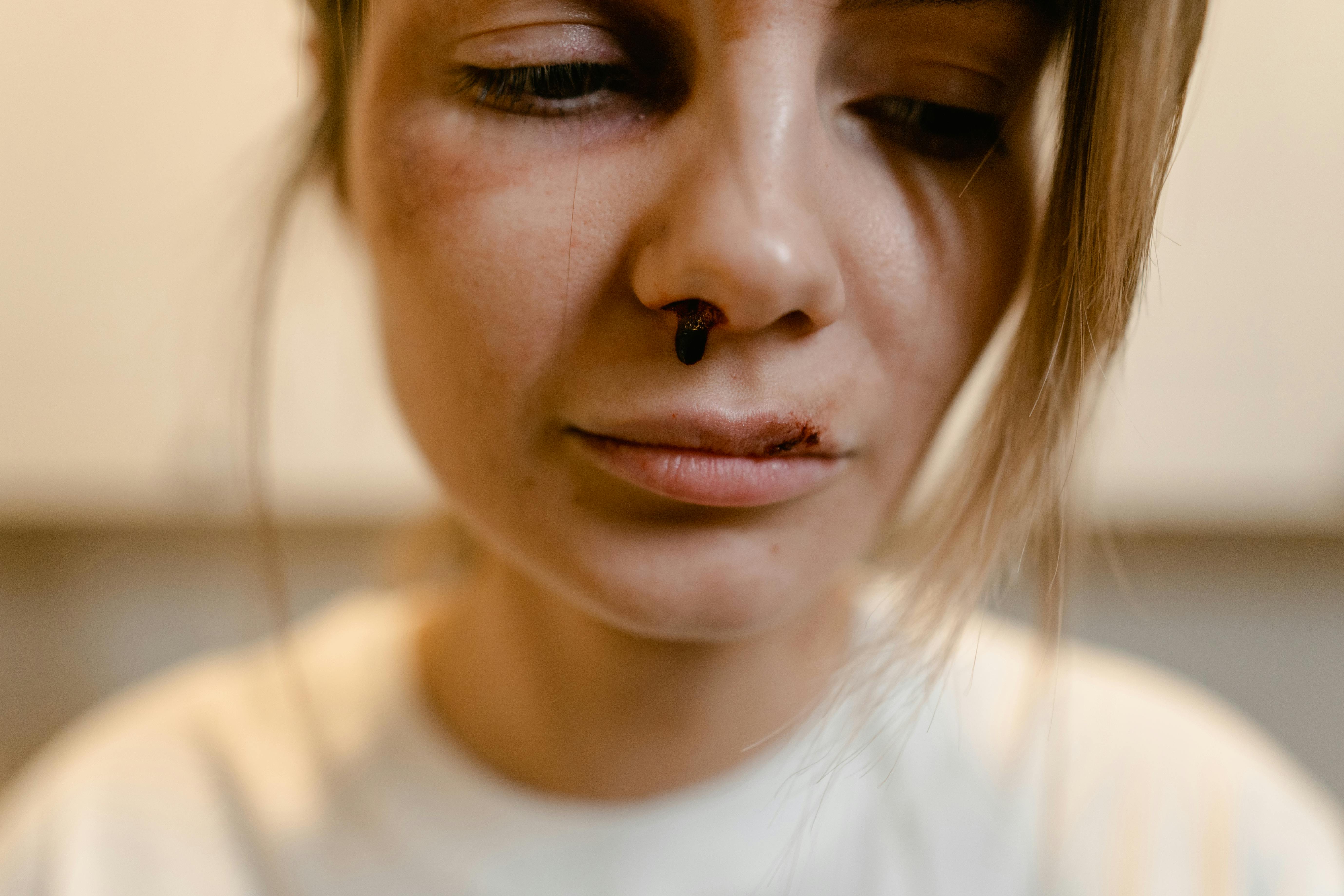 close up shot of a sad woman in white shirt