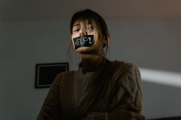 A Low Angle Shot Of A Woman In Knitted Sweater Seeking For Help