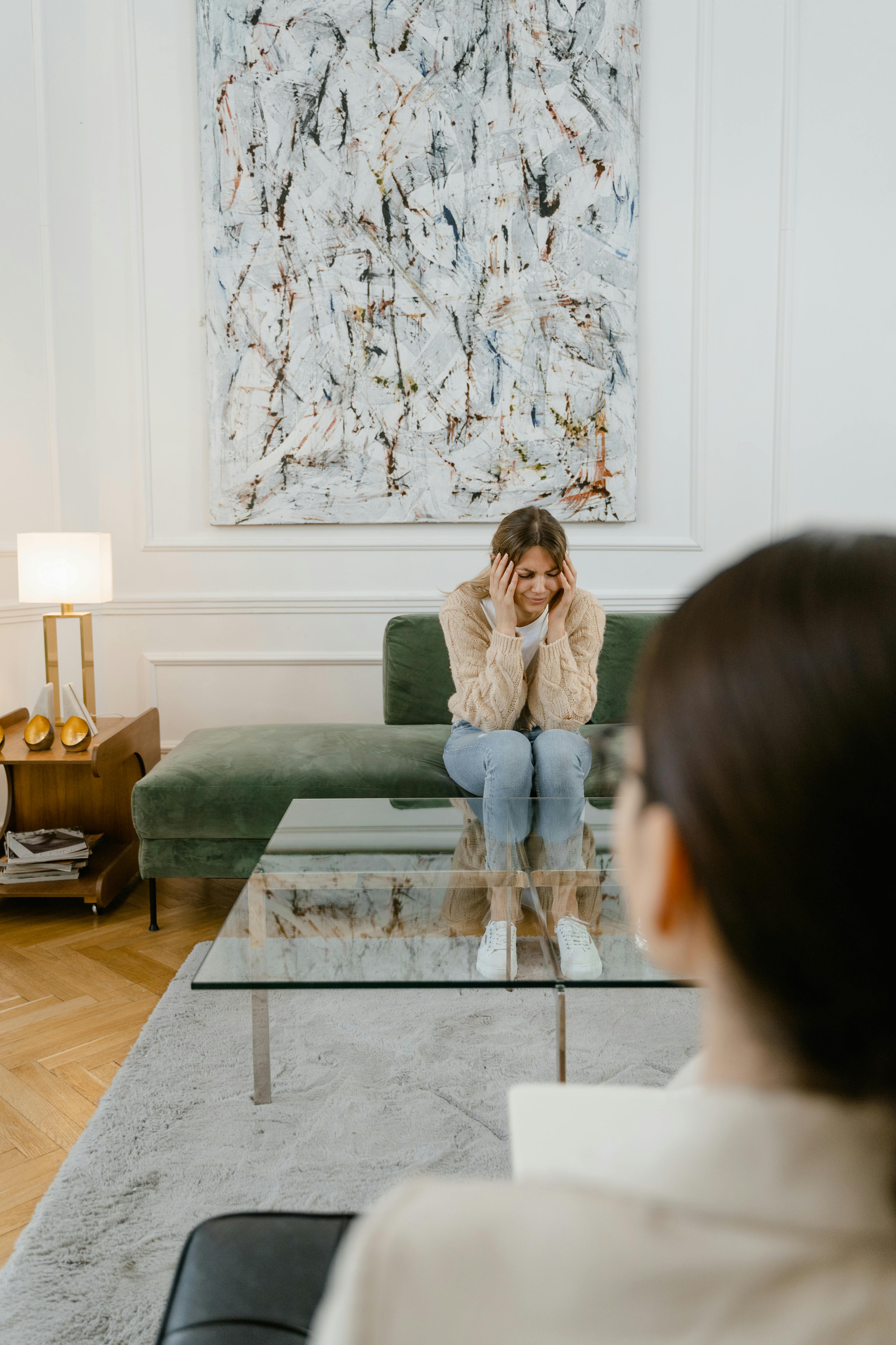 a sad woman sitting on a sofa