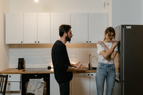 Free Man and Woman Having a Quarrel at the Kitchen  Stock Photo