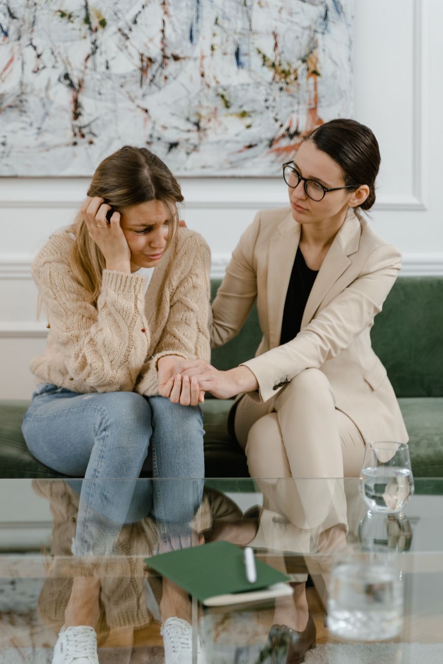 Counselor comforting a client resting on a couch during therapy