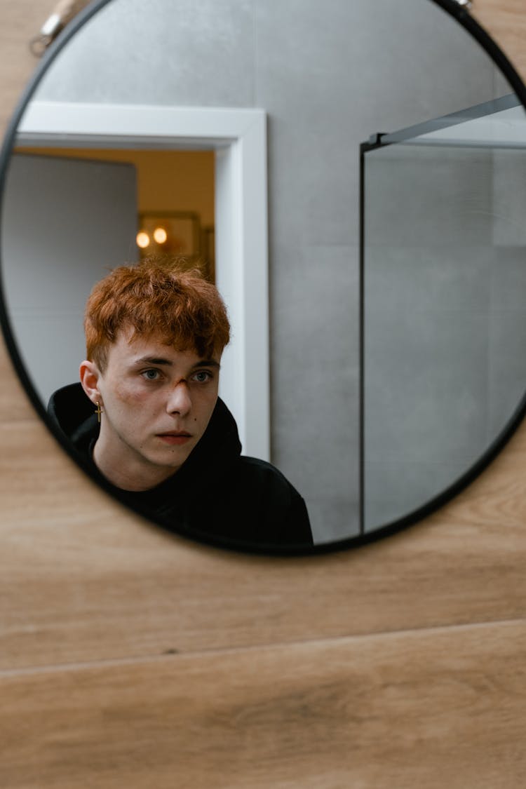 Reflection Of A Boy In The Round Mirror
