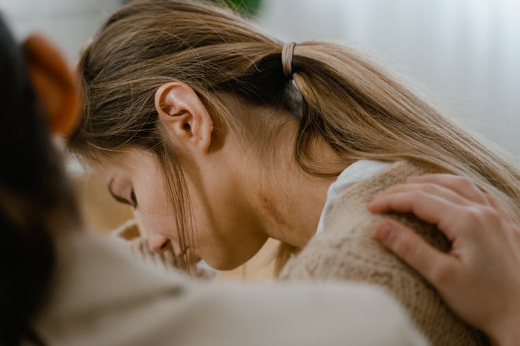 Woman Crying With A Hand On Her Shoulder 