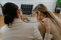 Person Comforting the Sad Woman