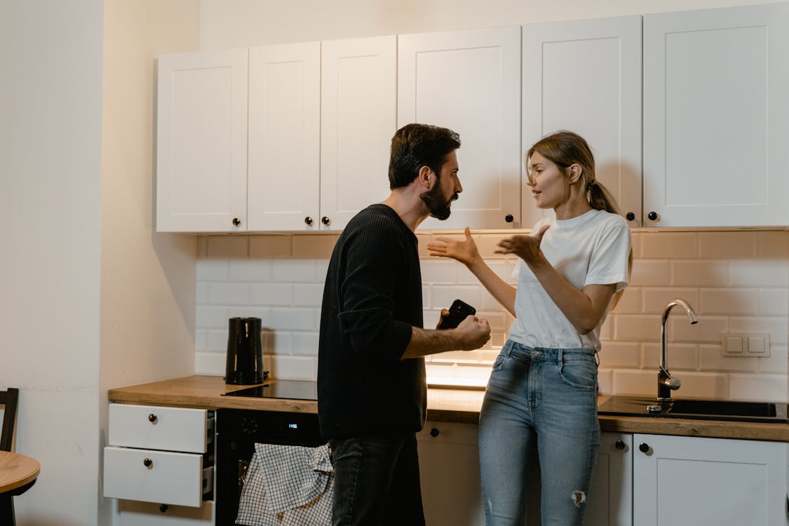 Free Man and Woman Arguing in a Kitchen Stock Photo